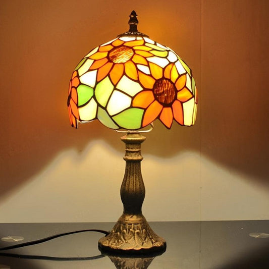 Tiffany style lamp with colorful stained glass shade, adding elegance to a bedroom nightstand.